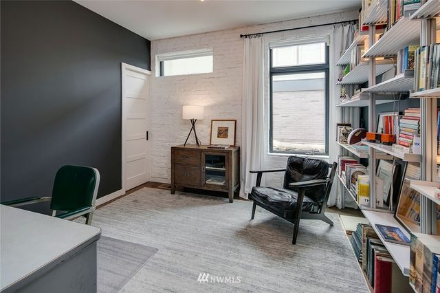 a livingroom with workspace and a couch