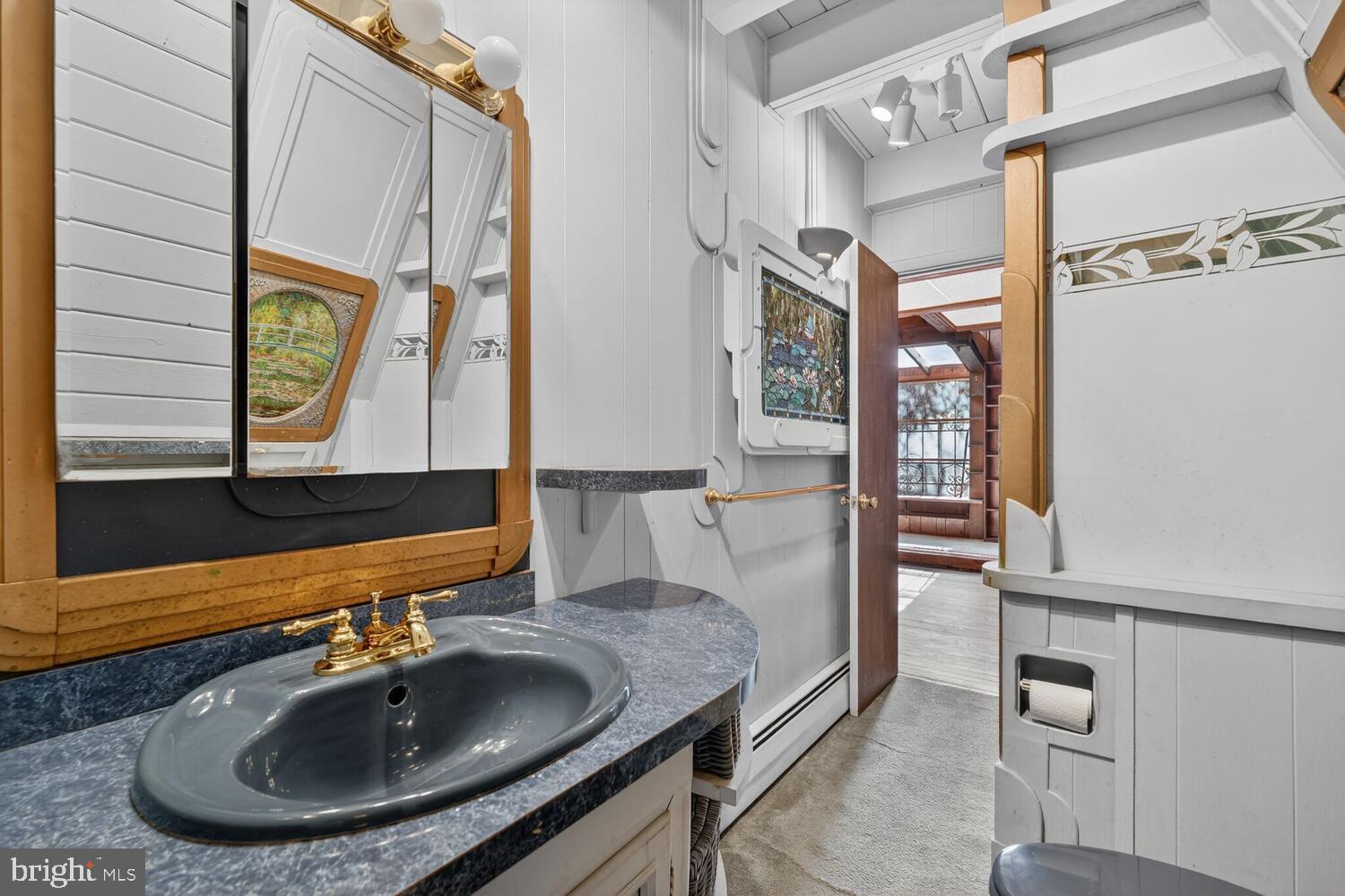 31 Hayward Court Takoma Park, MD 20912 - Photo 22 of 30 a bathroom with a sink and a mirror