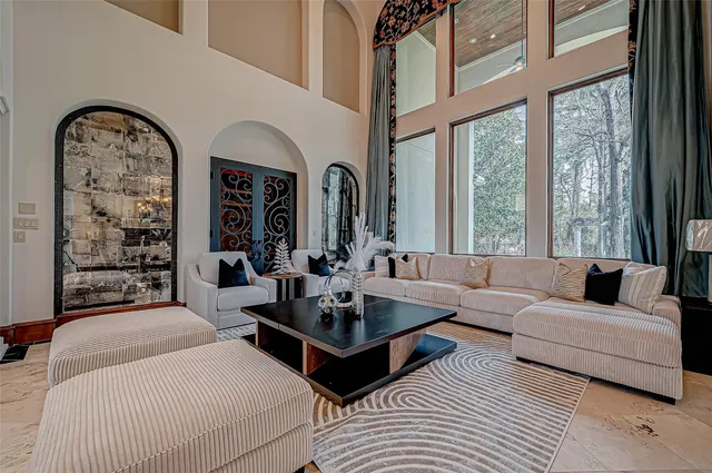 a living room with furniture and large windows