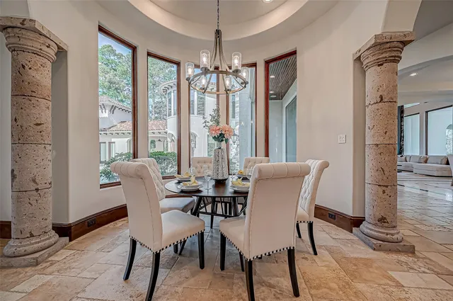 a living room with furniture and large windows
