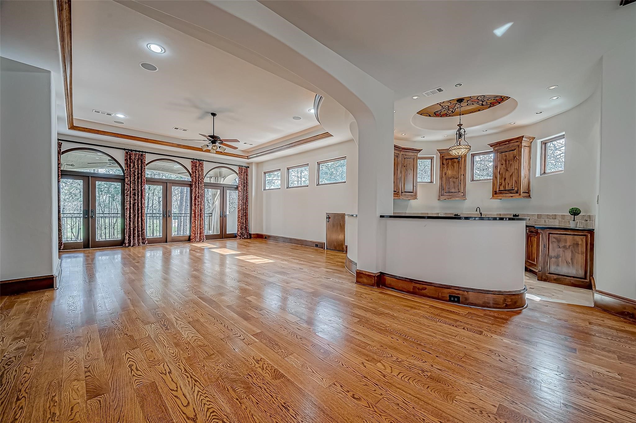 3 Congressional Circle Spring, TX 77389 - Photo 43 of 48 an empty room with wooden floor and kitchen view