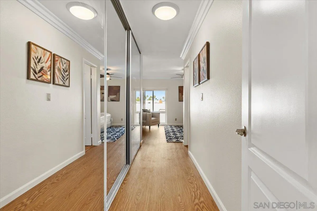 6333 Mt Ada Road, Unit 279 San Diego, CA 92111 - Photo 11 of 21 a view of a hallway with wooden floor and staircase