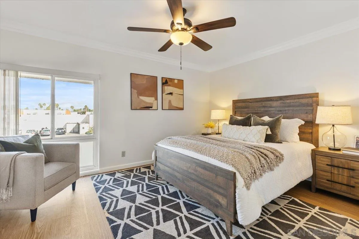 6333 Mt Ada Road, Unit 279 San Diego, CA 92111 - Photo 12 of 21 a bedroom with a bed and a chandelier