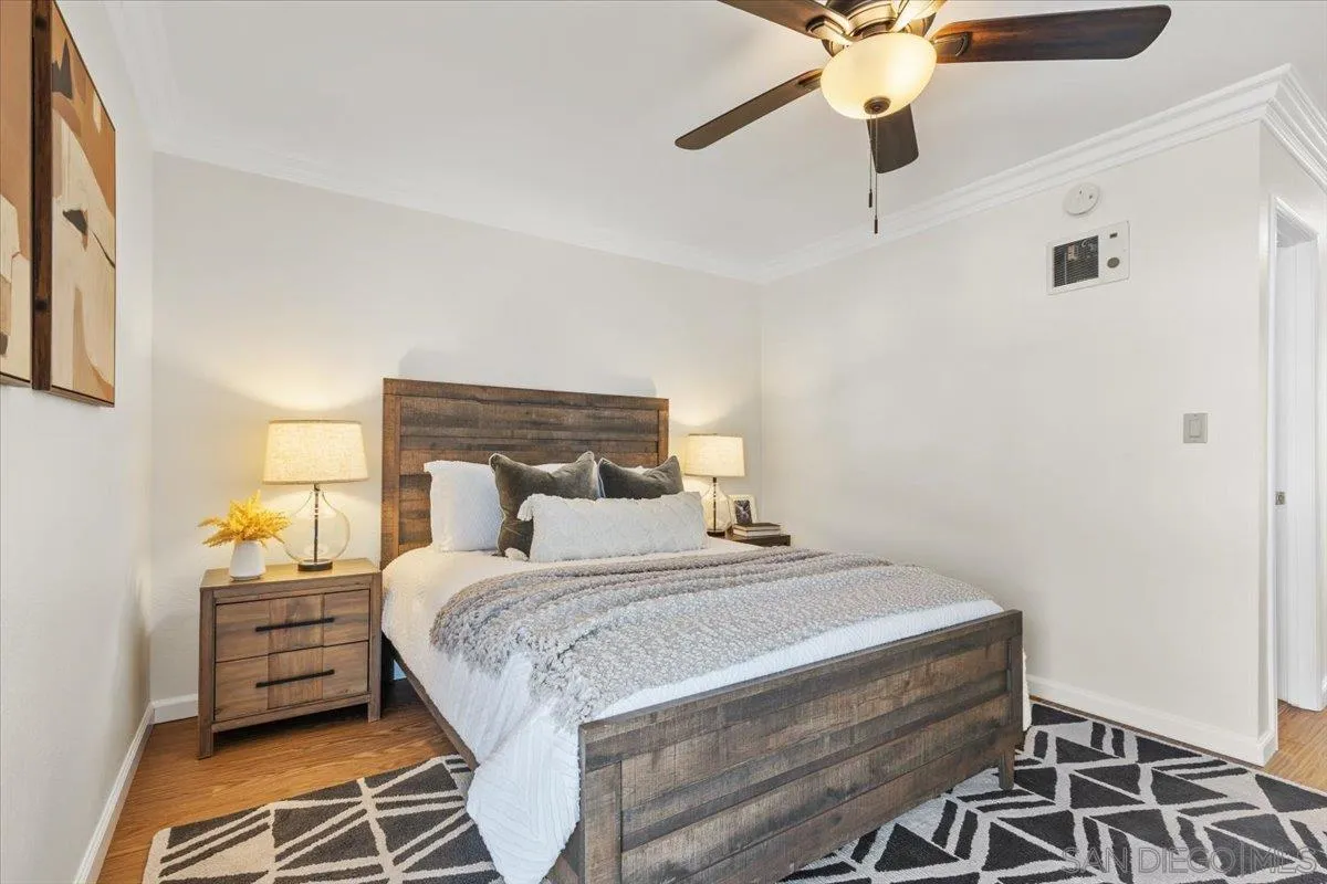 6333 Mt Ada Road, Unit 279 San Diego, CA 92111 - Photo 13 of 21 a bedroom with a bed and a chandelier