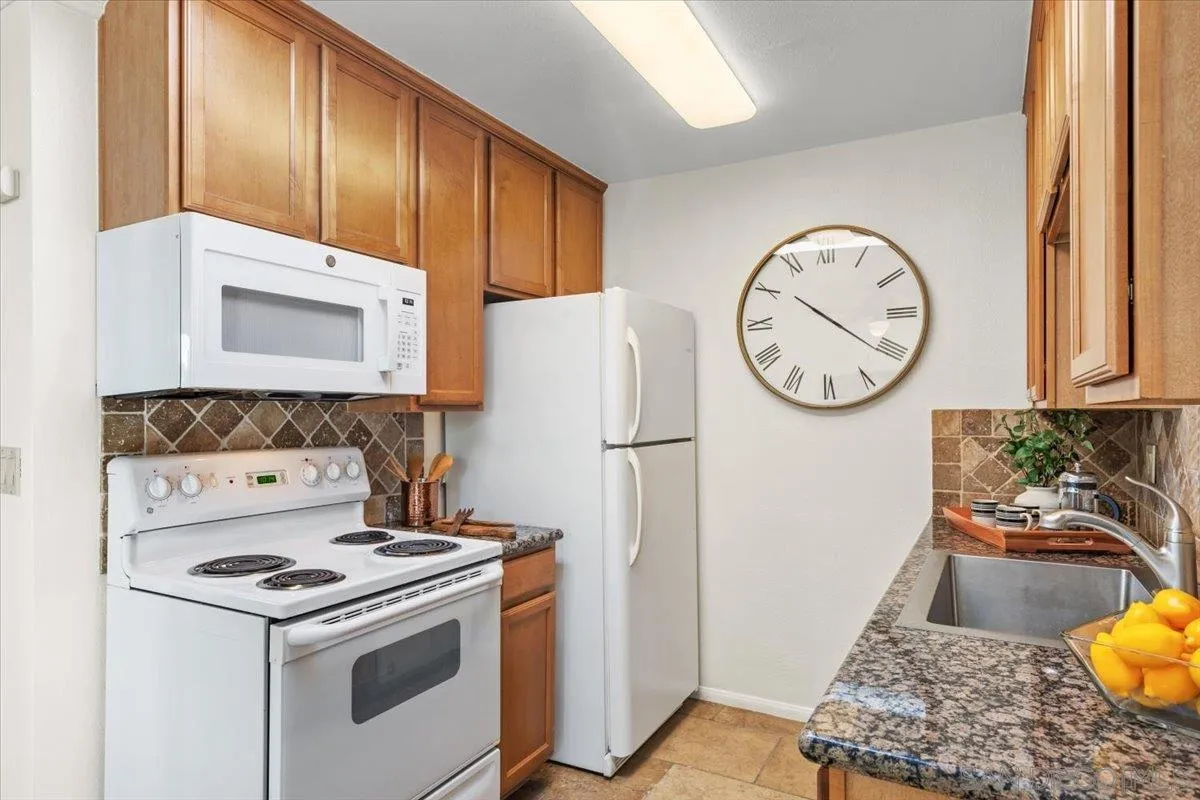 6333 Mt Ada Road, Unit 279 San Diego, CA 92111 - Photo 8 of 21 a kitchen with a stove a refrigerator and a cabinets