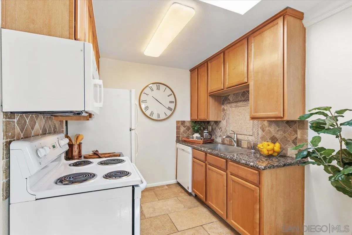 6333 Mt Ada Road, Unit 279 San Diego, CA 92111 - Photo 9 of 21 a kitchen with stainless steel appliances granite countertop a sink stove and cabinets
