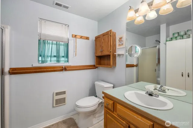 a bathroom with a sink a toilet and mirror