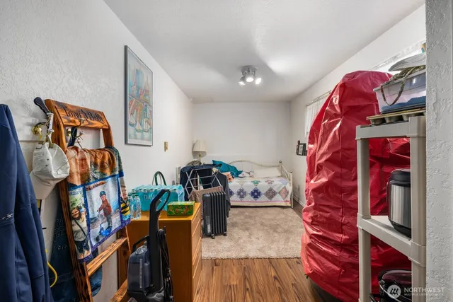 a view of a living room with clothes and shoes