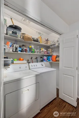 a utility room with cabinets washer and dryer