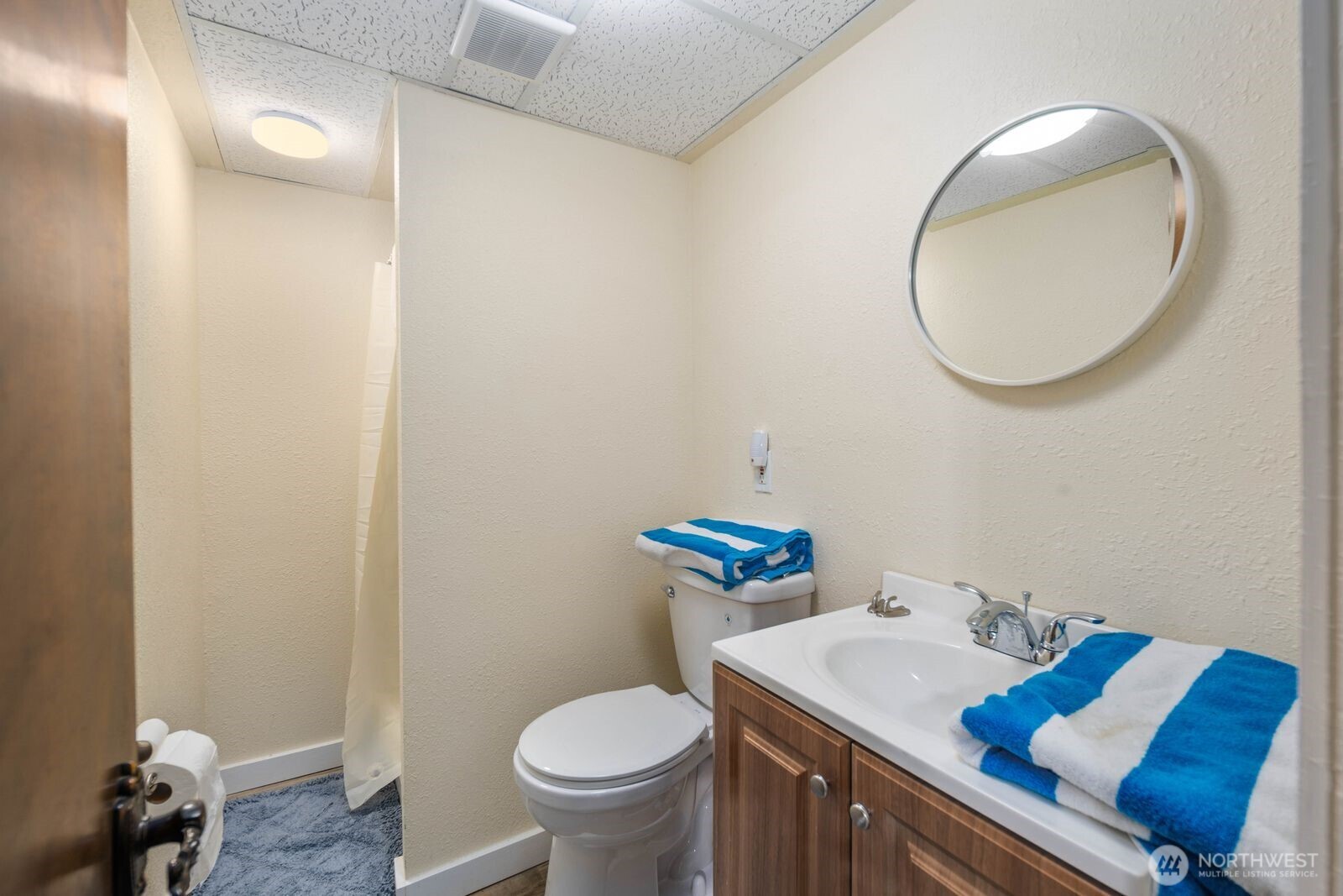 5874 Sherry Place Ferndale, WA 98248 - Photo 19 of 27 a bathroom with a sink toilet and a mirror