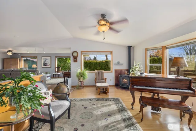 a living room with furniture large window and a table