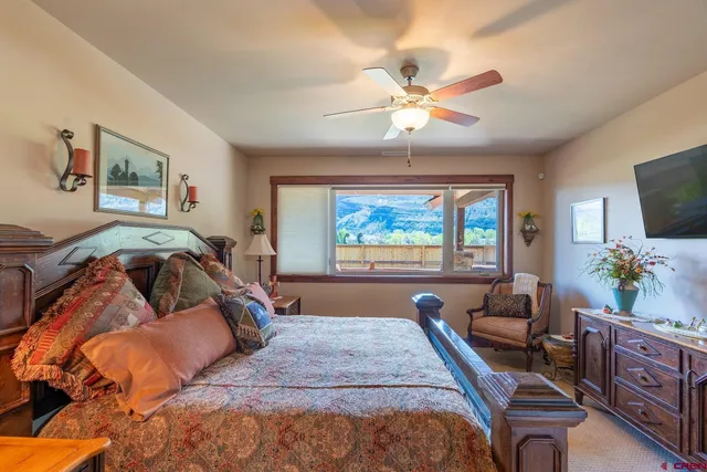 a bedroom with furniture and a flat screen tv