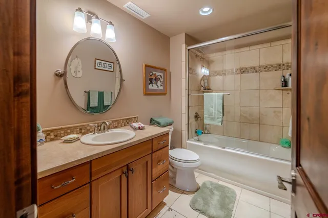 a bed room with a bed and a chandelier