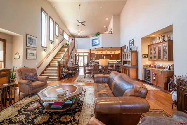 a living room with furniture a rug and kitchen view