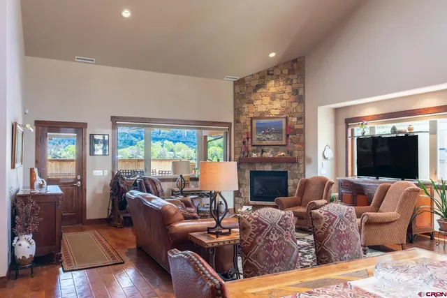 a living room with fireplace furniture and a flat screen tv