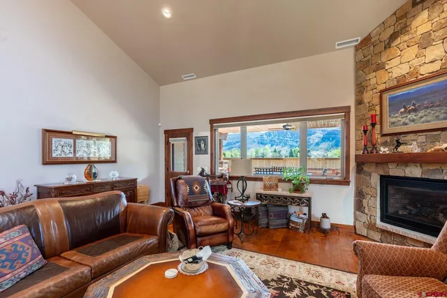 a living room with furniture ceiling fan and a fireplace