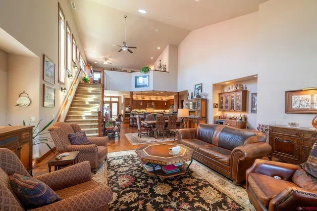 a living room with furniture kitchen and a chandelier