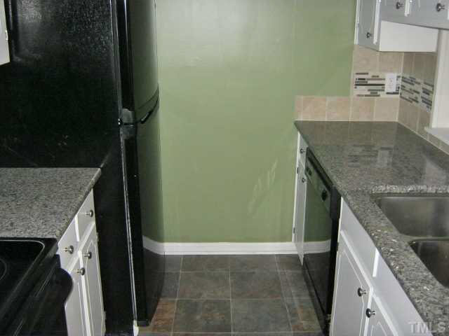 3551 Mill Run Raleigh, NC 27612 - Photo 8 of 23 a kitchen with granite countertop a sink and a stove