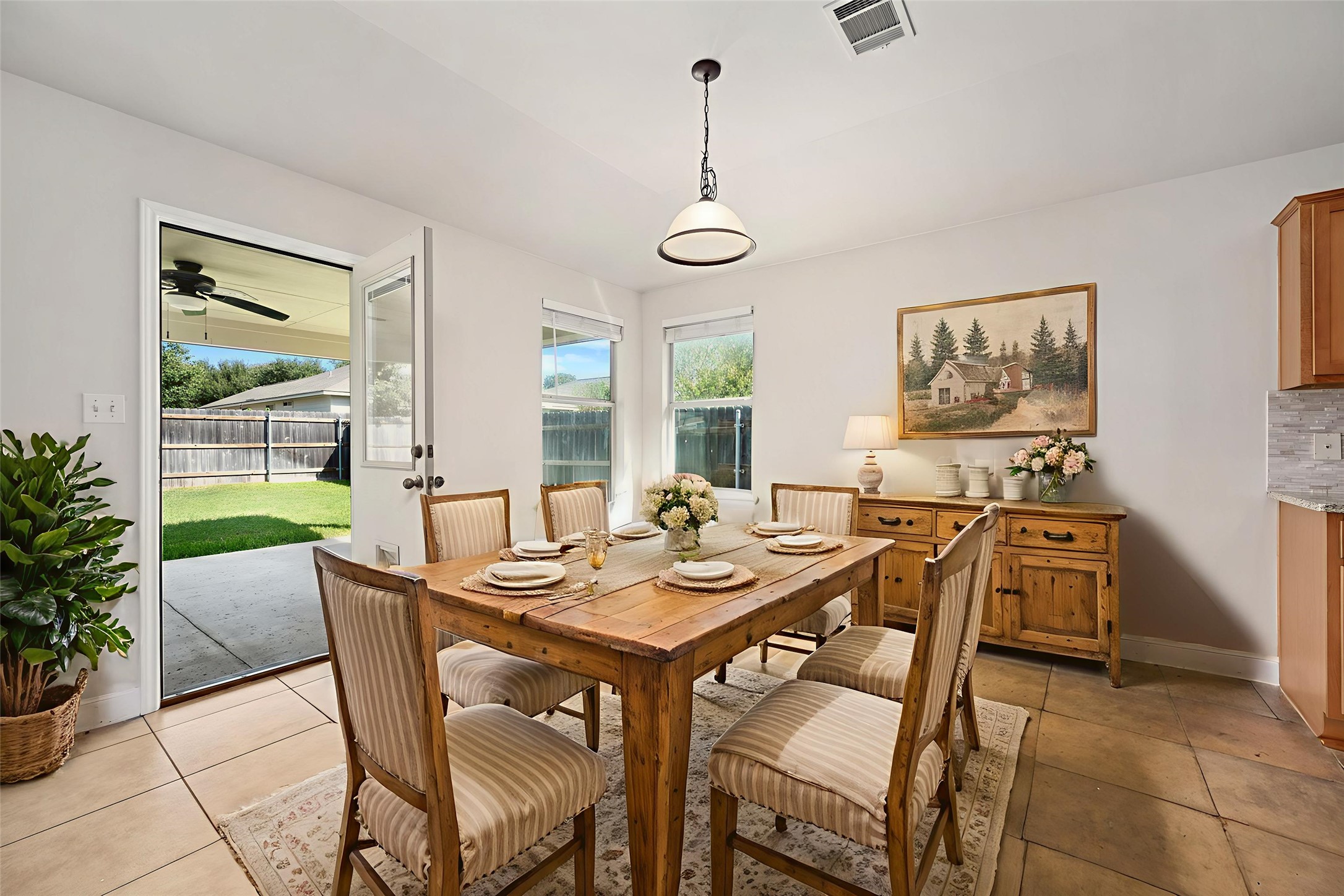 7817 Squirrel Hollow Drive Georgetown, TX 78628 - Photo 10 of 28 a view of a dining room with furniture wooden floor and a chandelier