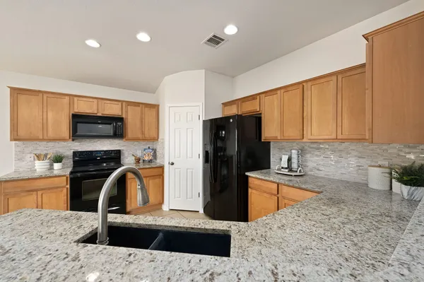 a view of kitchen and refrigerator