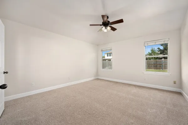a bedroom with a large bed and a window