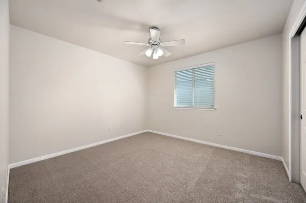 a bedroom with a bed and a potted plant