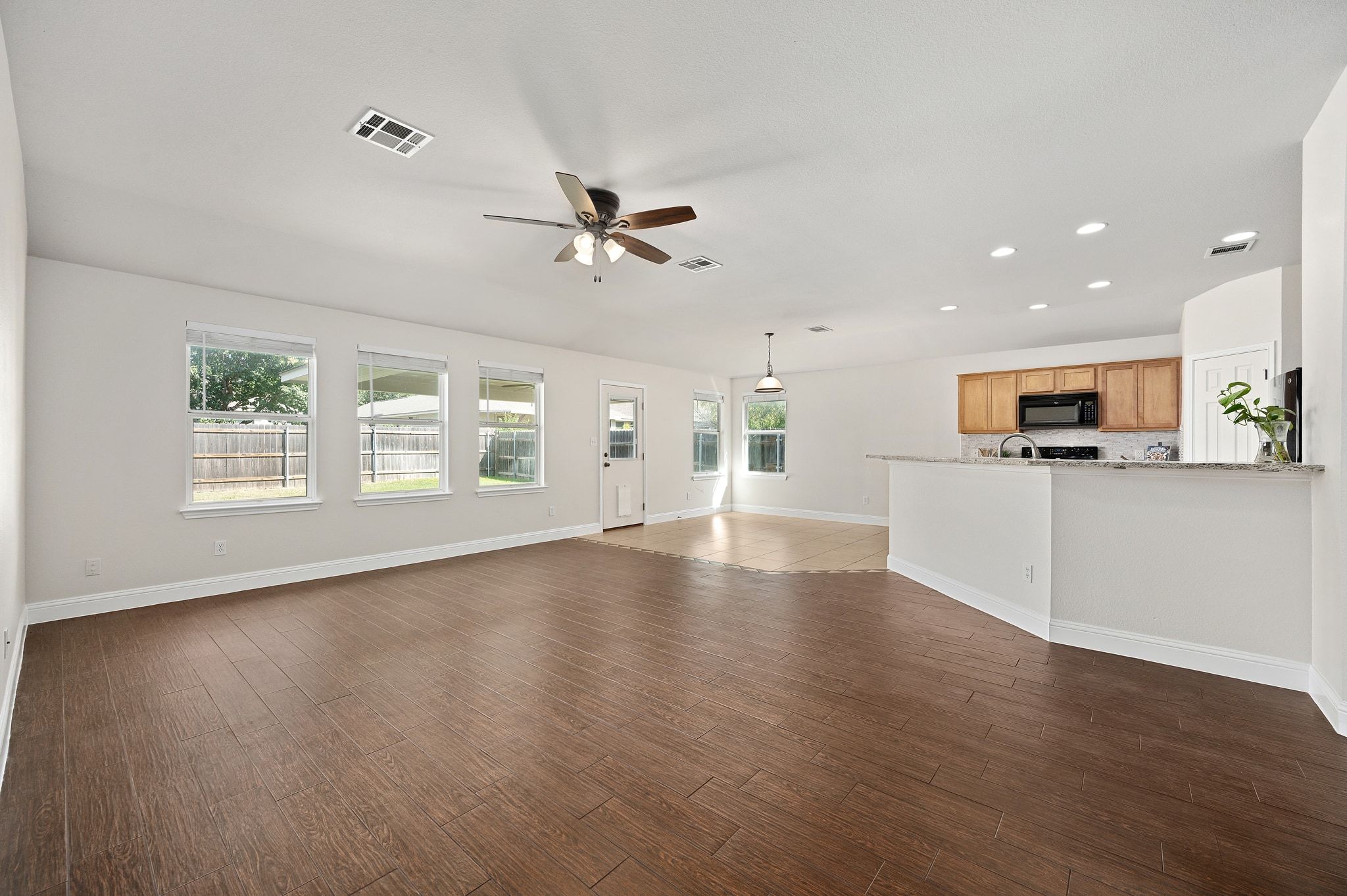 7817 Squirrel Hollow Drive Georgetown, TX 78628 - Photo 4 of 28 a view of an empty room with window and wooden floor