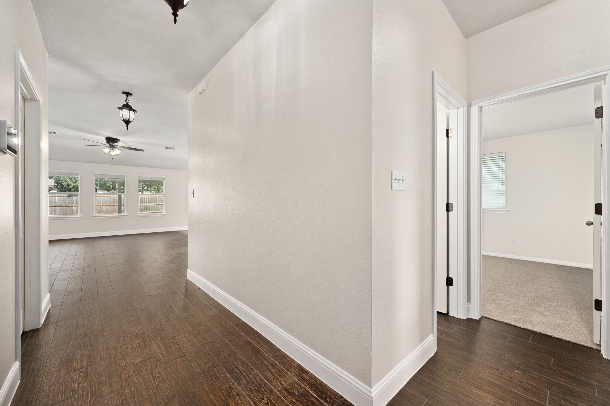 7817 Squirrel Hollow Drive Georgetown, TX 78628 - Photo 5 of 28 a view of an empty room with wooden floor and a window