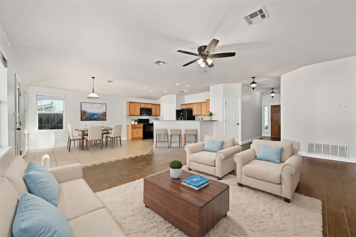 7817 Squirrel Hollow Drive Georgetown, TX 78628 - Photo 6 of 28 This photo is virtually staged to show furniture opportunities within the open living/dining areas.