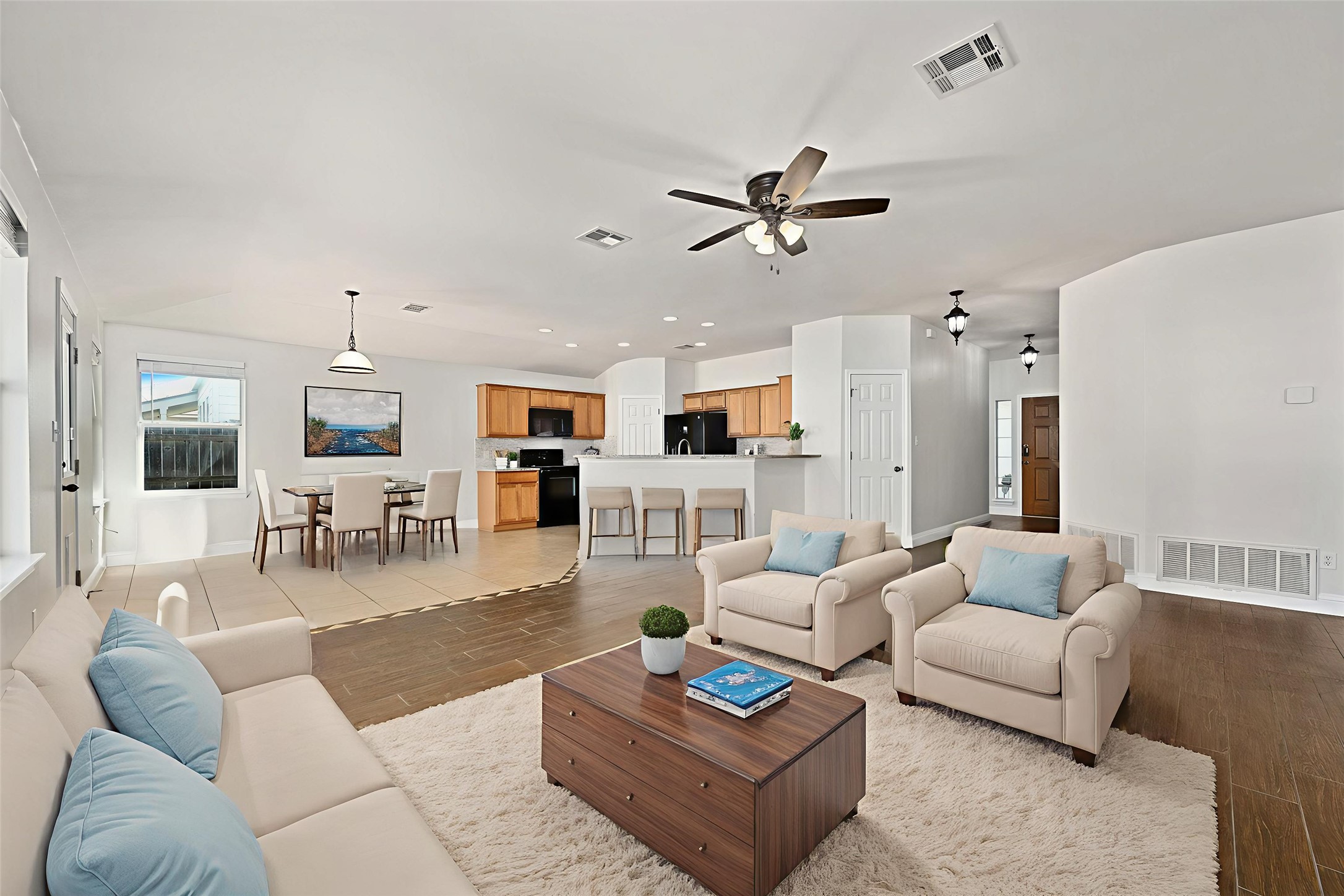 7817 Squirrel Hollow Drive Georgetown, TX 78628 - Photo 6 of 28 a living room with furniture a rug and a chandelier