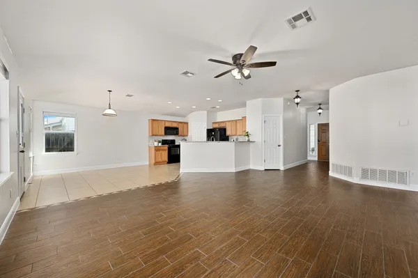 a view of a kitchen with a sink and a refrigerator