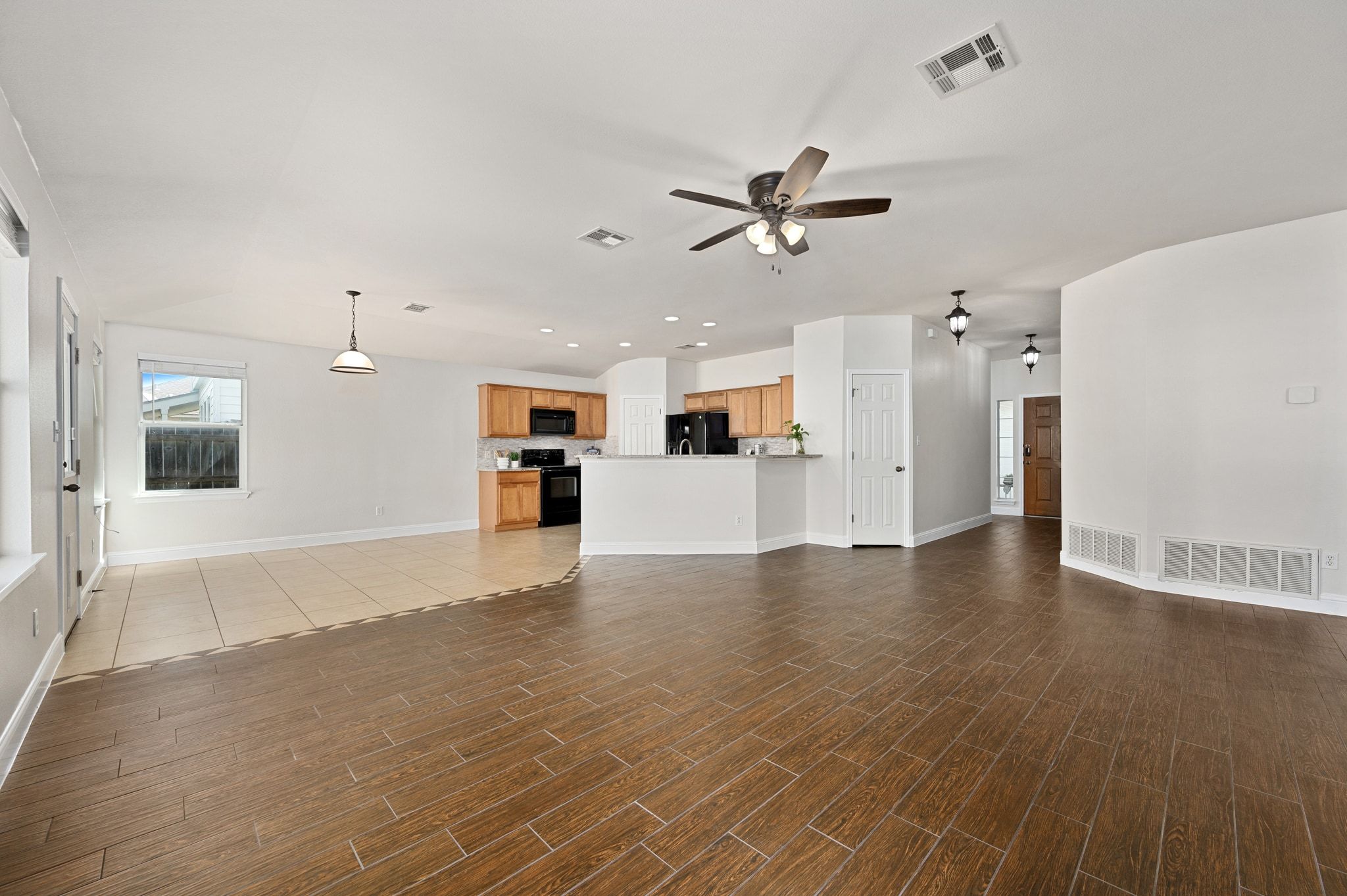 7817 Squirrel Hollow Drive Georgetown, TX 78628 - Photo 7 of 28 a view of a kitchen with a sink and a refrigerator