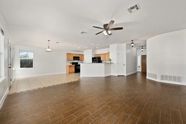 a view of a kitchen with a sink and a refrigerator