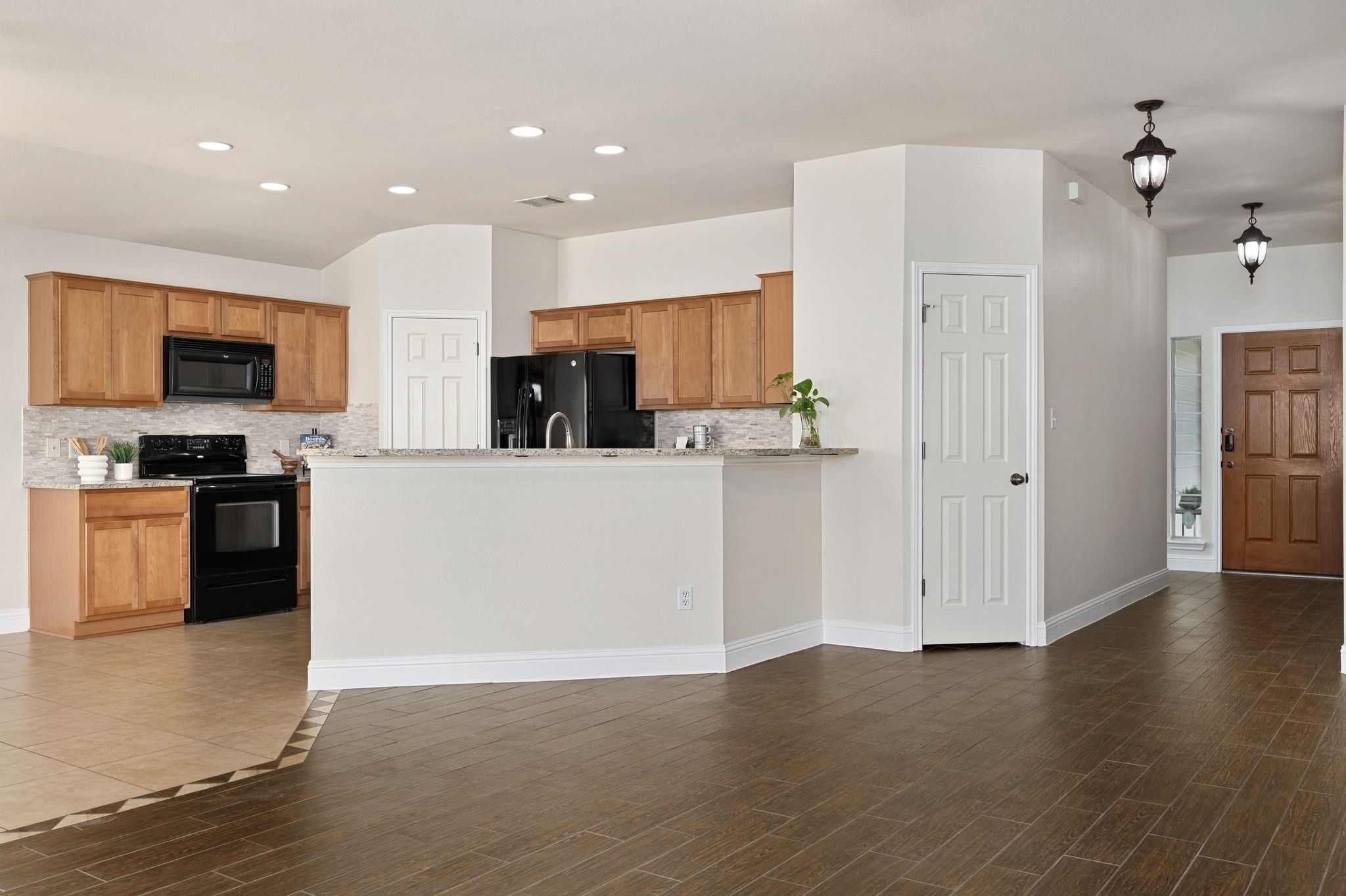 7817 Squirrel Hollow Drive Georgetown, TX 78628 - Photo 9 of 28 a kitchen with stainless steel appliances a refrigerator sink and microwave