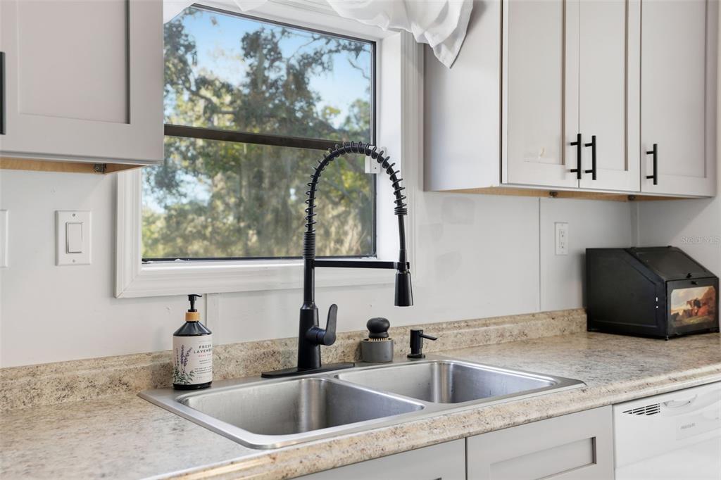 17539 Edwin Terrace Hudson, FL 34667 - Photo 15 of 38 a kitchen with a sink and a window