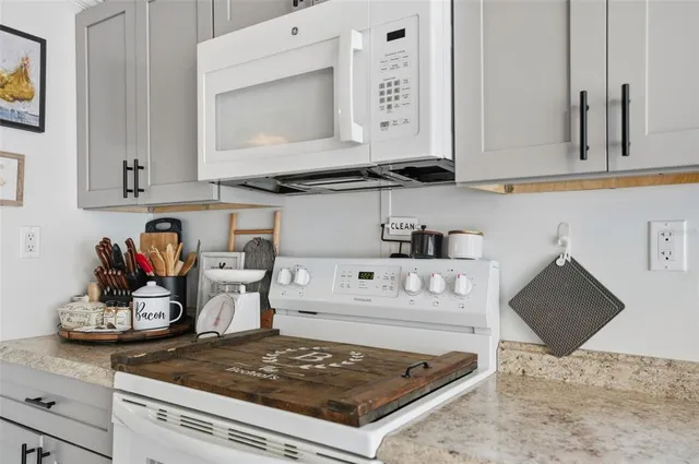 a kitchen with stainless steel appliances kitchen island granite countertop a refrigerator and a sink