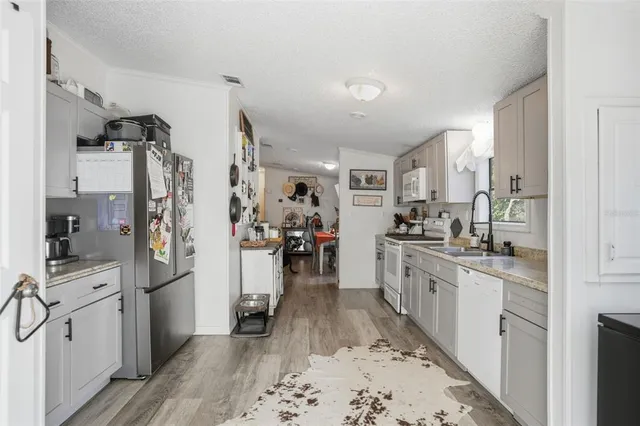 a kitchen with a refrigerator and cabinets