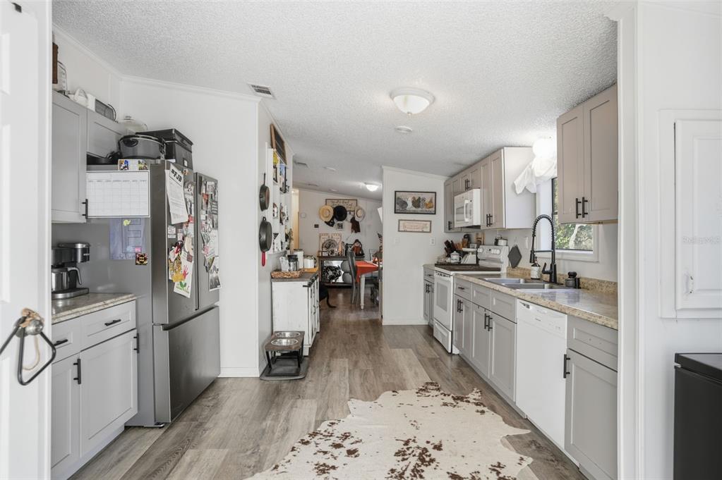 17539 Edwin Terrace Hudson, FL 34667 - Photo 17 of 38 a kitchen with stainless steel appliances kitchen island granite countertop a refrigerator and a sink