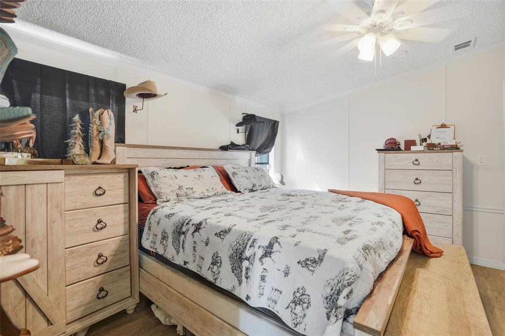 17539 Edwin Terrace Hudson, FL 34667 - Photo 23 of 38 a bedroom with a bed and a dresser