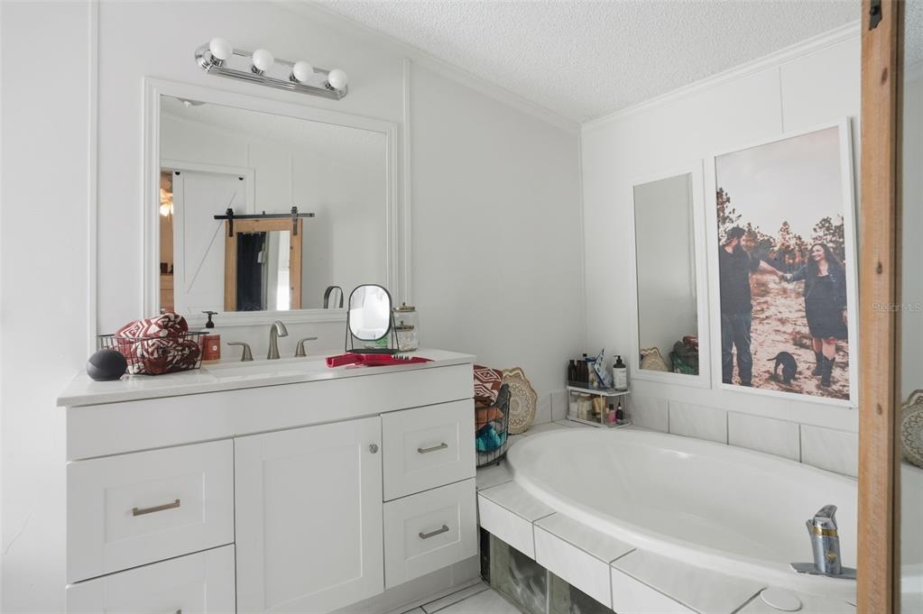 17539 Edwin Terrace Hudson, FL 34667 - Photo 27 of 38 a bathroom with a tub sink and mirror