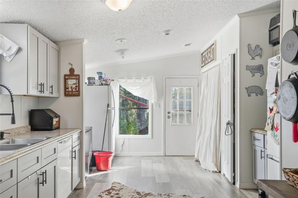 17539 Edwin Terrace Hudson, FL 34667 - Photo 30 of 38 a kitchen with stainless steel appliances granite countertop a refrigerator and a sink