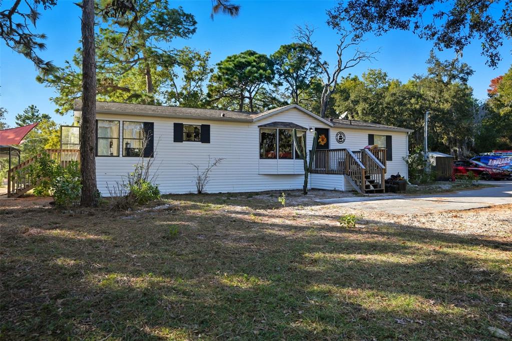 17539 Edwin Terrace Hudson, FL 34667 - Photo 3 of 38 a front view of a house with a yard