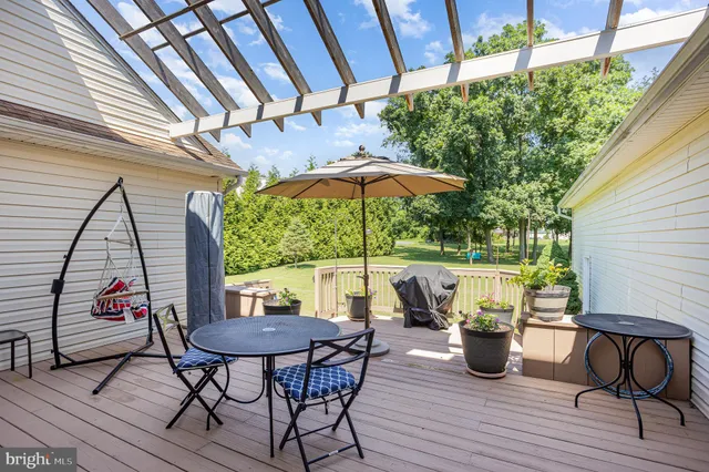 a view of backyard with outdoor seating and wooden floor