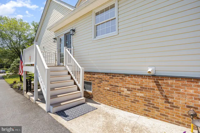 a view of outdoor space with deck and white walls