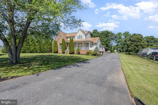 a front view of a house with a yard and trees