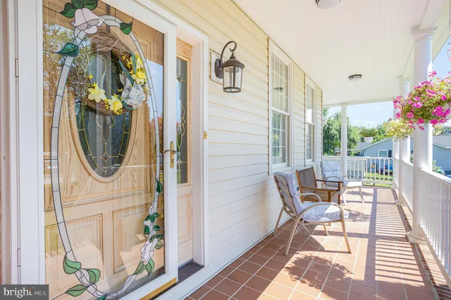 a front view of a house with outdoor seating