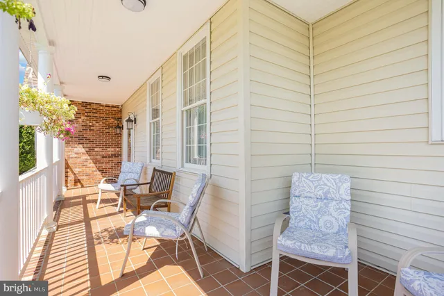 a balcony with table and chairs