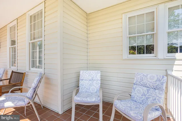a brick building with a bench and chair