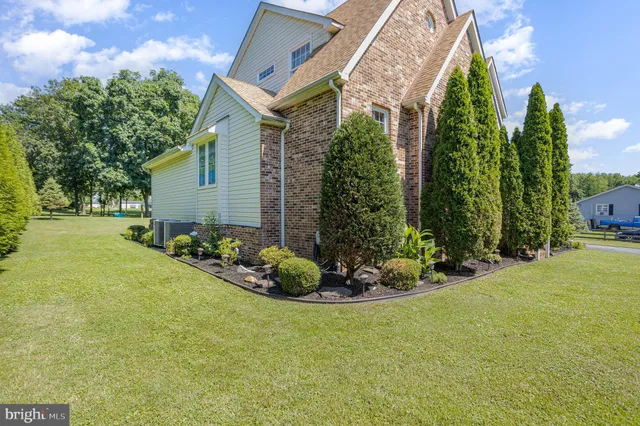 a front view of a house with a garden and porch