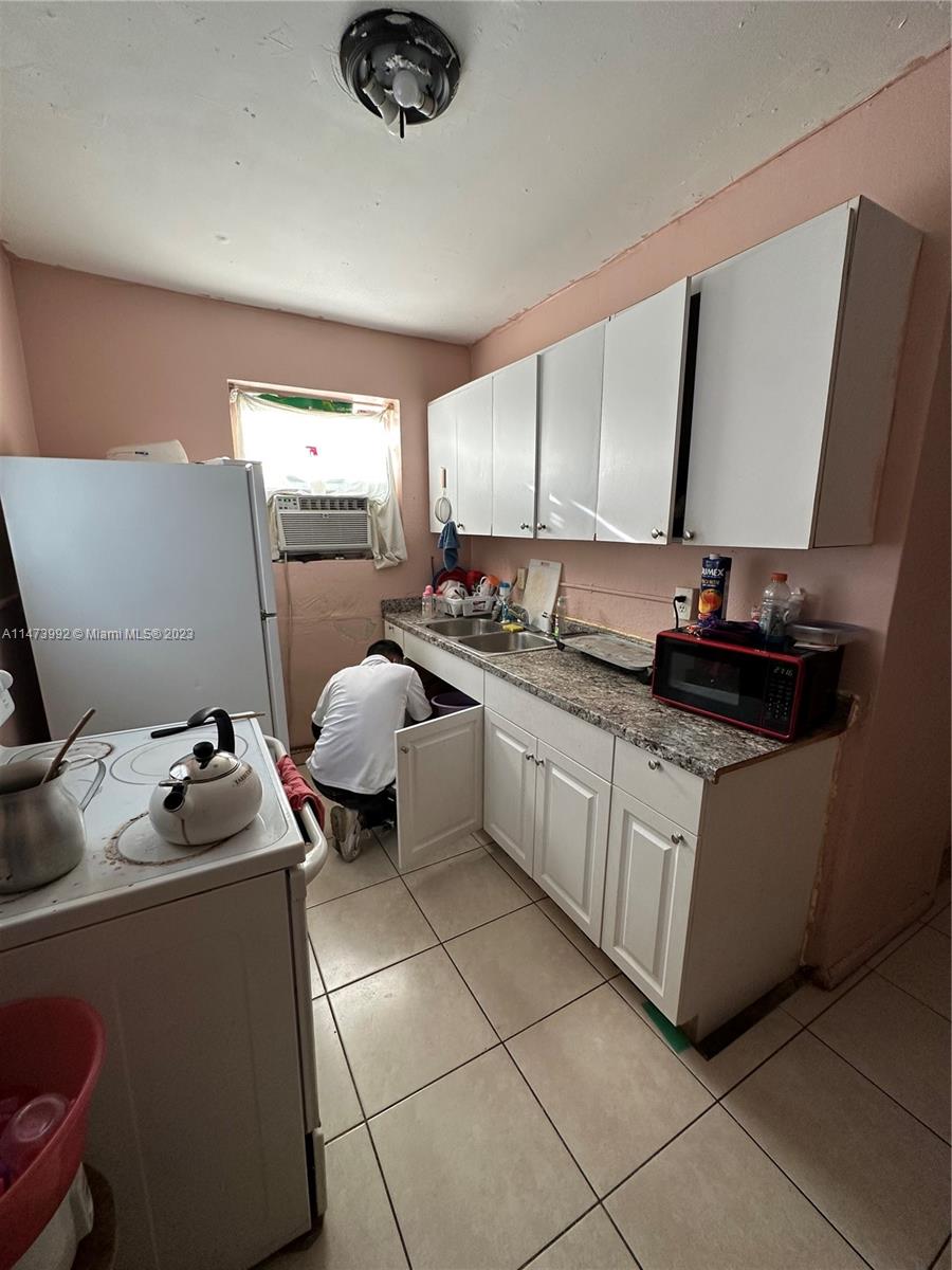660 Southwest 7th Street Homestead, FL 33030 - Photo 4 of 4 a kitchen with a sink appliances and cabinets